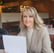 a woman sitting at a table with a piece of paper