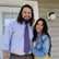 a man and woman standing in front of a house