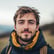 a man with a beard and a backpacker