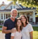 Smiling homeowner with family in front of remodeled house by Garnet Painting & Remodeling GA
