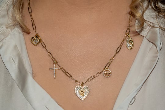 a woman wearing a necklace with a cross on it