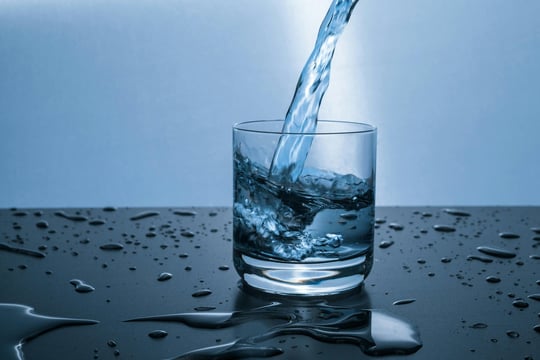 agua cayendo en un vaso de cristal