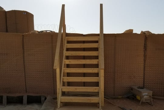 Stairs leading up unto a dirt wall
