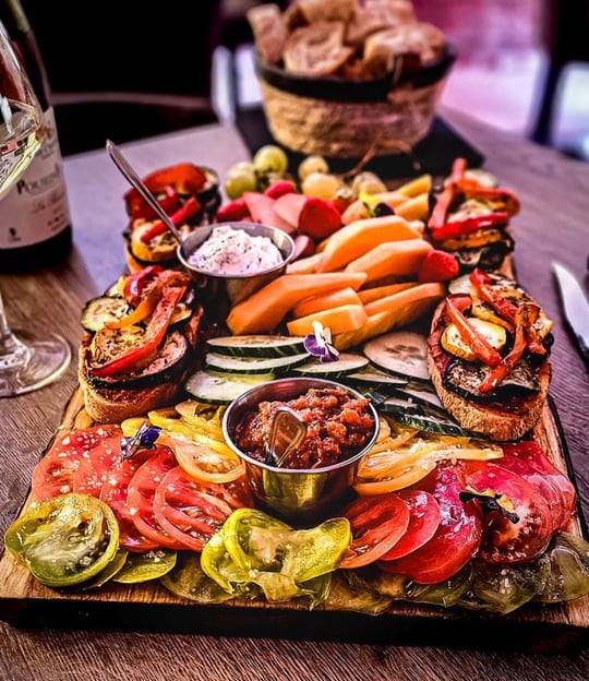 a platter of food and wine glasses