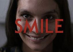 lady wit creepy smile with the word smile written across her face
