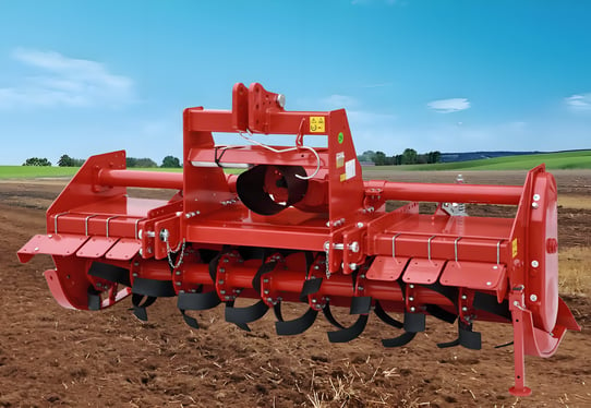 a red tractor with a red disc on a farm