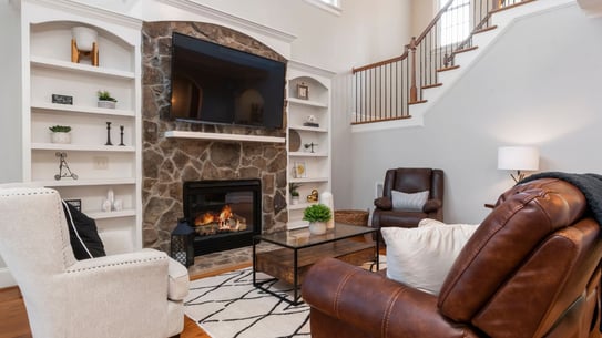 a living room with a fireplace and a tv
