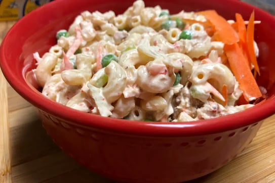 Finished tuna pasta salad in a red bowl ready to serve