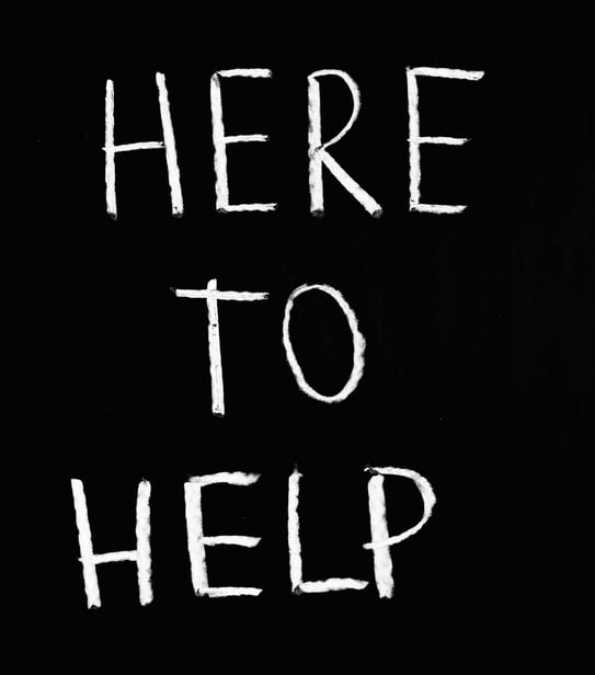 📝 "Here to Help" handwritten on blackboard-style background