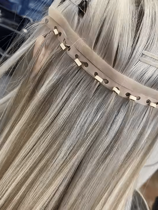 Close-up van een Butterfly Weft haarextension-installatie. Ultradunne en flexibele wefts zijn stevig