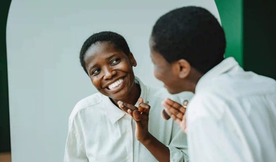 woman smiling in the mirror