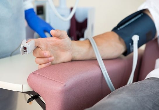 a person with a blood pressure monitor on their arm