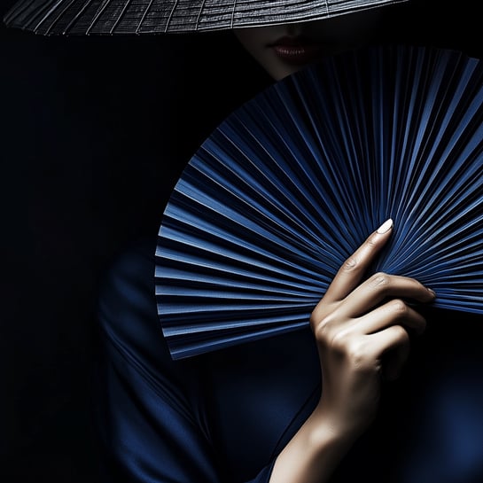 Shadowy Asian girl in black hat behind a blue fan