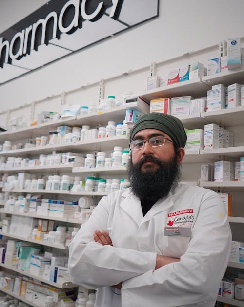 a man in a pharmacy office with a beardless man in a pharmacy