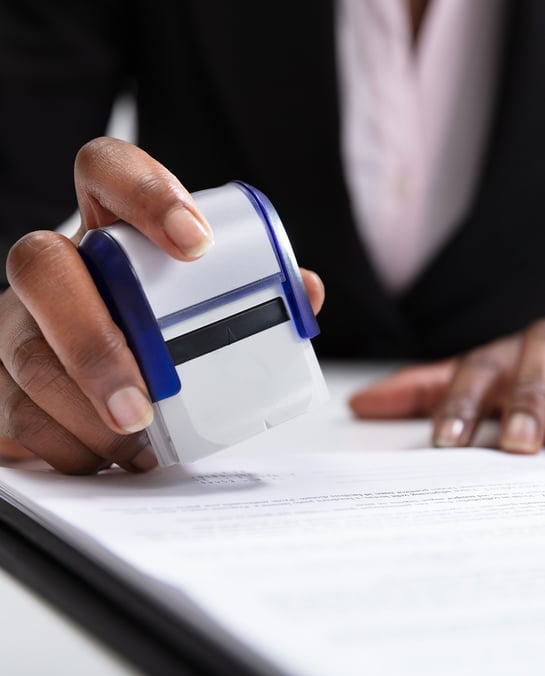 mobile notary stamping a parental concept form for travel
