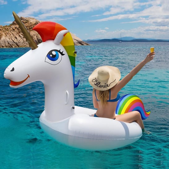 a woman in a swimsuit sitting on a floatie in the water