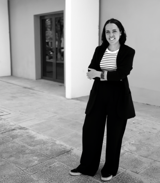 a woman in a suit and striped shirt