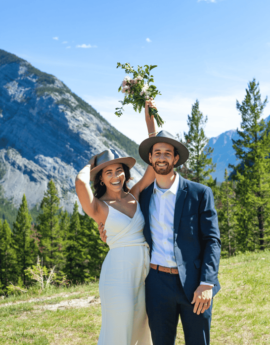 Bride and groom celebrating their banff elopement with the rockies in the background