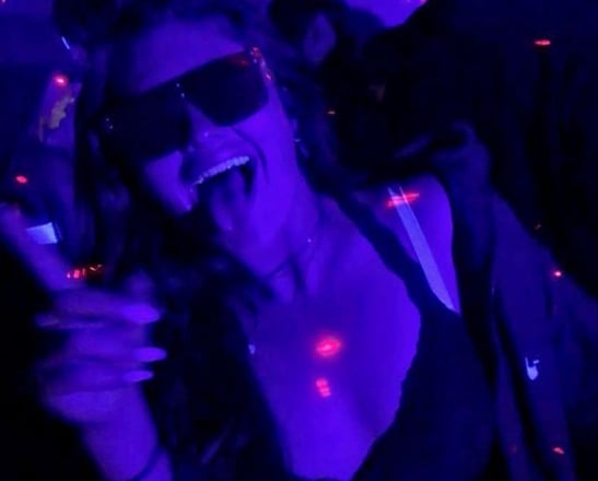 a woman in a black bra top and sunglasses during the Riga Pub Crawl