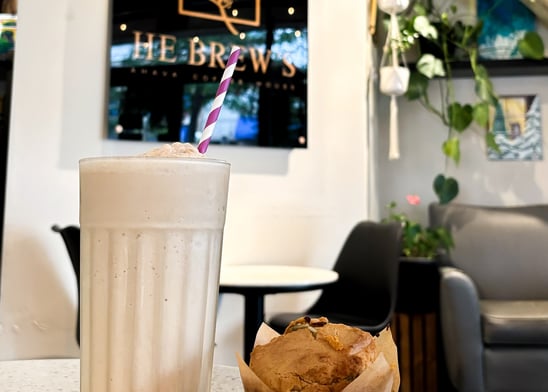 a muffin and an ice latte drink in a restaurant