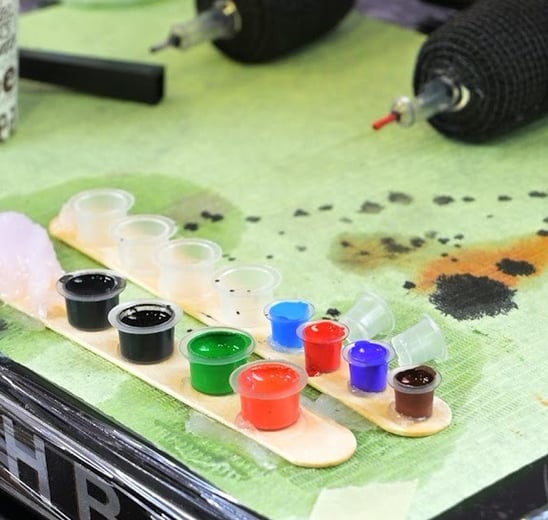 a table with paint and brushes and paint