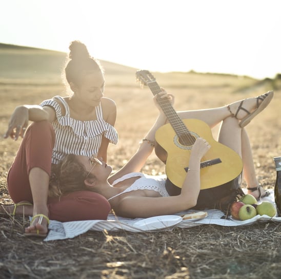 two women playing guitar