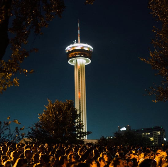 A crowd of san antonio texas people in front of the Tower of Americas