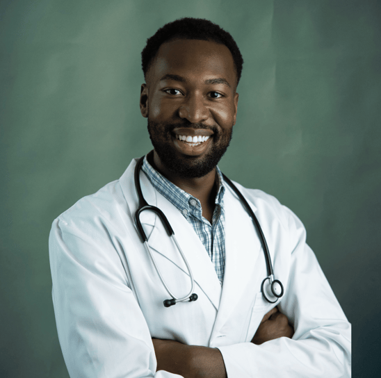 Médico negro sorrindo com estetoscópio no pescoço e braços cruzados