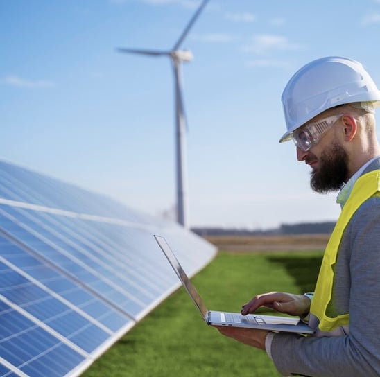 a man in a hard hat and a laptop computer