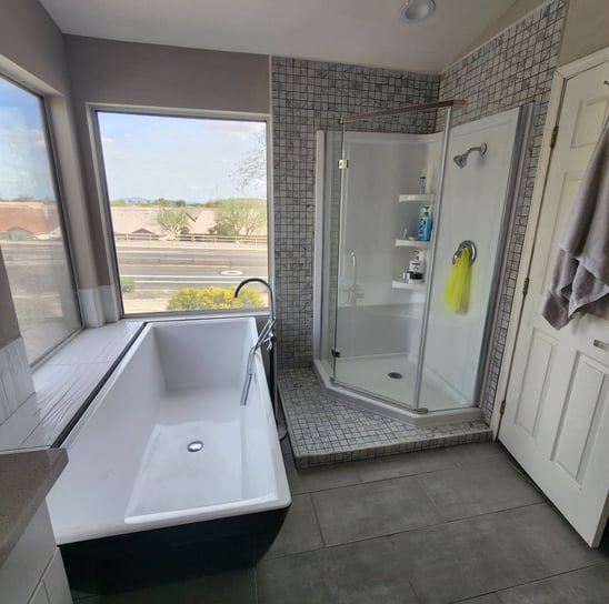 a bathroom with a bathtub and a shower