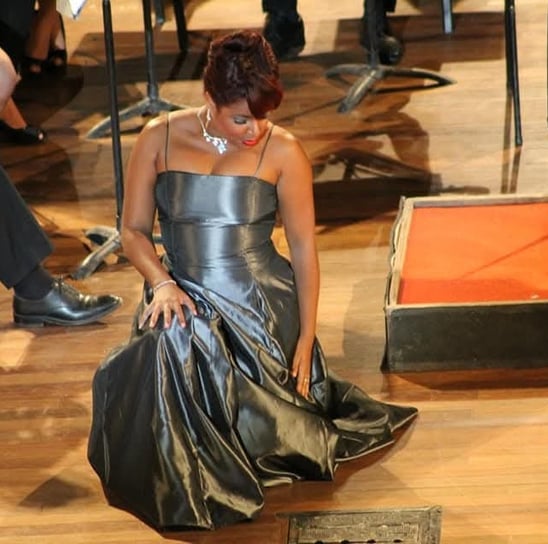 a woman in a silver dress with a dress on