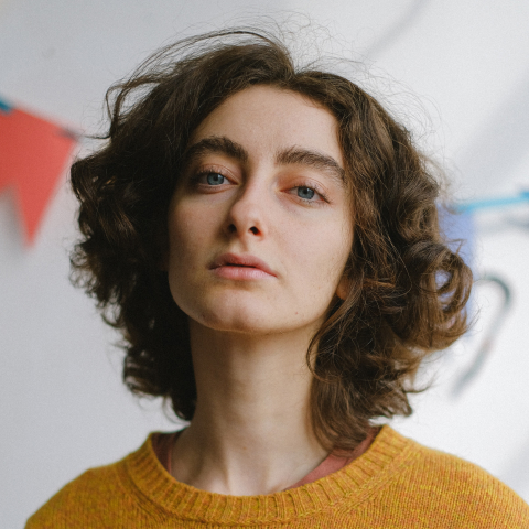 a woman with a yellow sweater and a yellow sweater