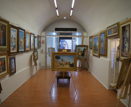 a room with a lot of paintings and paintings