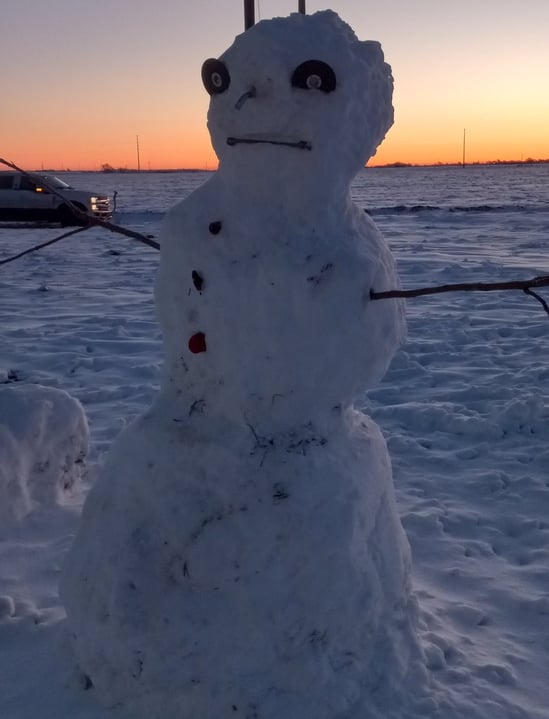 A cheerful snowman built by a guest on a snowy evening at Hidden Garden RV Park, west of Wolfforth, Texas. call 806-782-8255