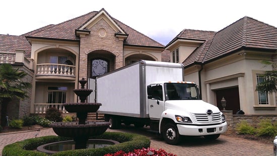 a moving truck parked in front of a house