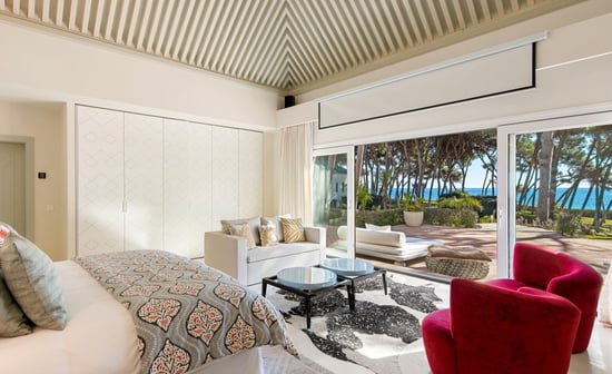 Master suite in the guest house of Villa El Rincon, Marbella, featuring stunning garden and sea views.