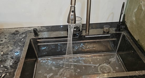 a kitchen sink with a faucet and a faucet faucet