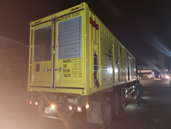 a truck with a yellow trailer parked on the side of the road