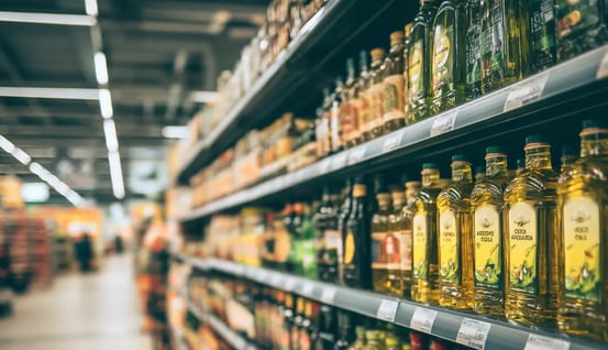 a shelf of olive oil bottles and olive oil