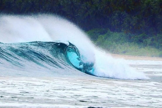 Beach break wave in Afulu. Fun peaks for surfing right out front.