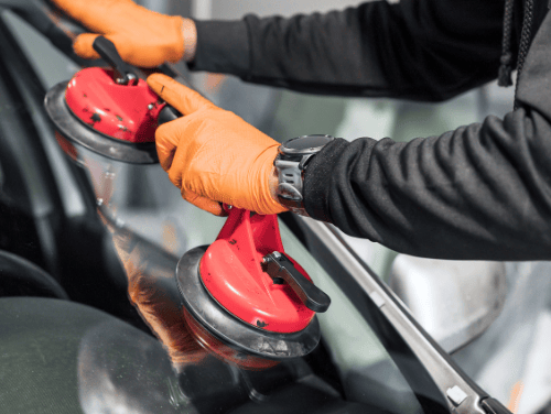 a person wearing gloves and gloves holding a red object