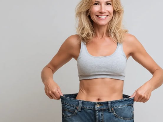a woman in a gray tank top and jeans jeans