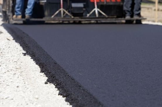 This is an image of an asphalt paver laying asphalt