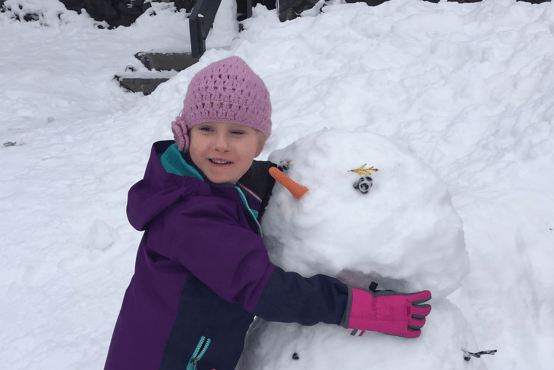 girl building snowman