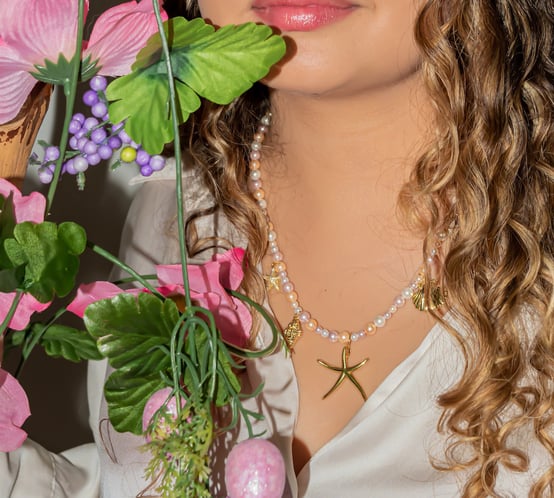 a woman with curly hair and a white shirt