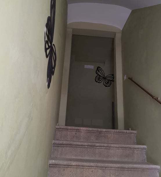 a stairway way with a butterfly on the wall