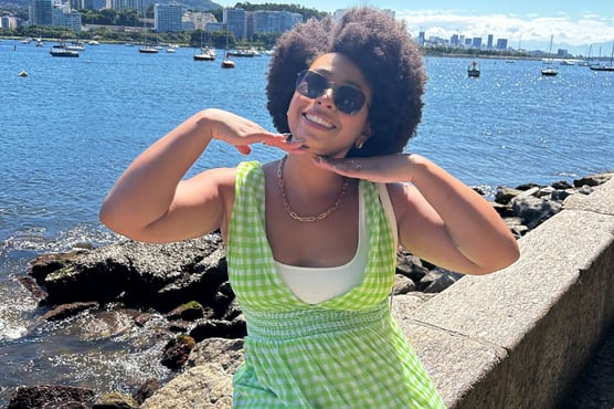 a woman in a green dress and sunglasses
