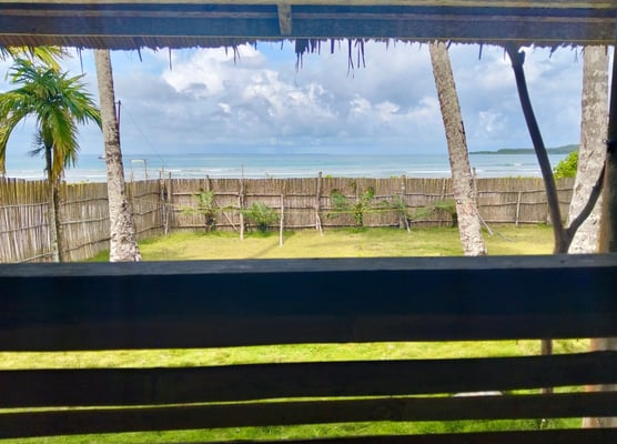 View from the deck at Afulu Surf Resort, overlooking the ocean with stunning sunsets.