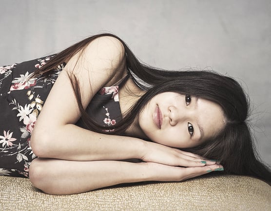Photograph of a beautiful young woman sleeping on a bench