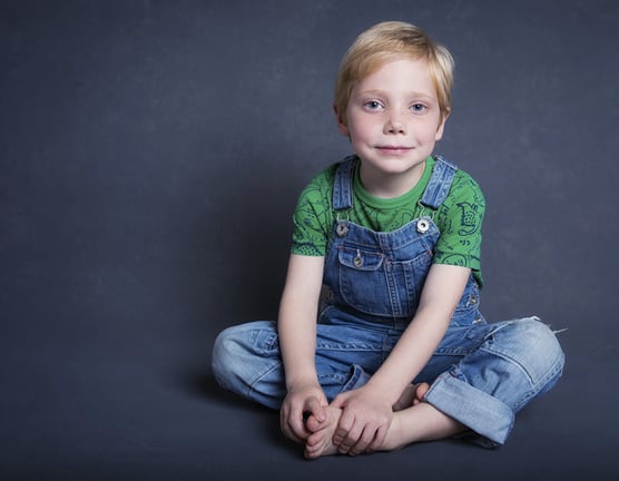 Photograph of a young boy on a blue background